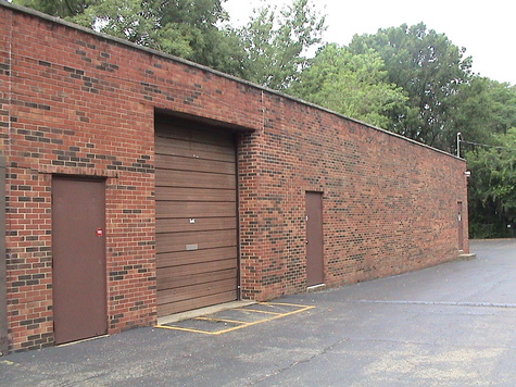 Large parking lot fenced/ drive in door
